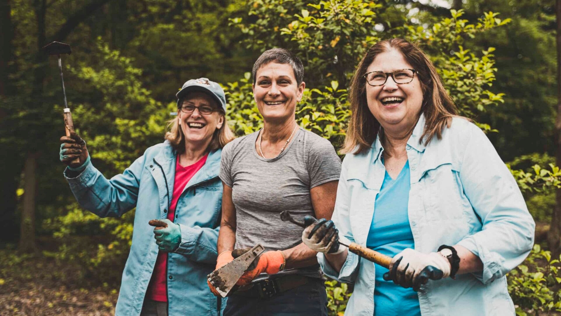 A smiling group of three female volunteers